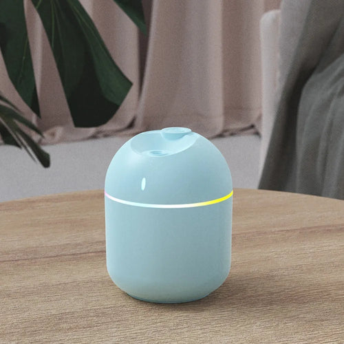 Humidificateur d’air cylindrique gris avec lumière d’ambiance et diffusion continue de brume.